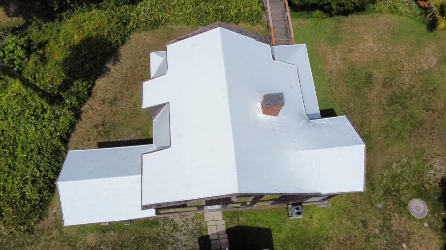 The same roof from above sealed watertight under a clean white RoofWrap membrane